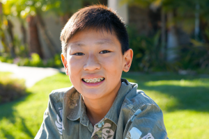 Child with dental braces smiling