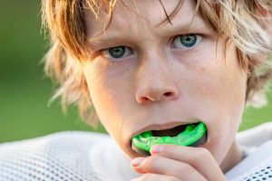 Boy using mouthguard